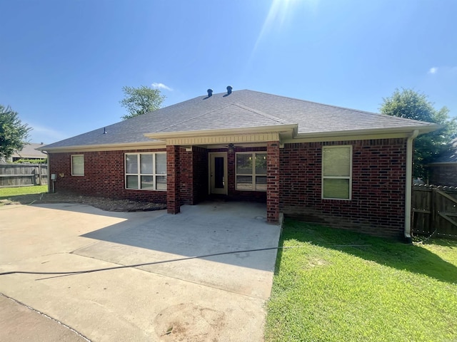 24 Tradewinds Dr, Cabot, AR 72023 - back of property featuring a patio, driveway, brick siding, and roof with shingles