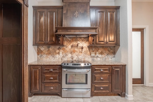 24 Tradewinds Dr, Cabot, AR 72023 - kitchen featuring stainless steel range with electric cooktop, premium range hood, backsplash, and light stone countertops