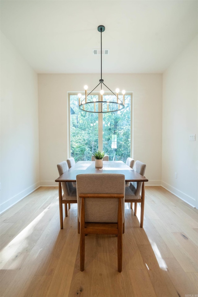 15112 Matterhorn Loop, Maumelle, AR 72113 - dining space with light wood-style floors and a chandelier