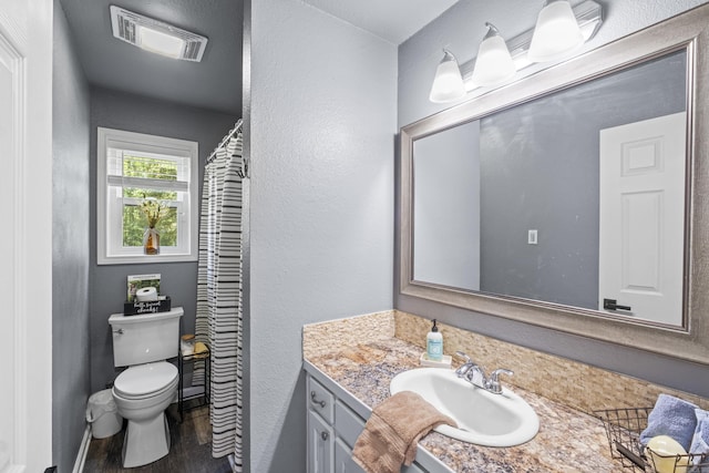 60 Pin Oak Dr, Lonoke, AR 72086 - bathroom featuring wood finished floors, vanity, and a textured wall