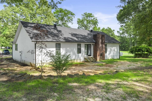 60 Pin Oak Dr, Lonoke, AR 72086 - back of property featuring entry steps, a shingled roof, and a chimney