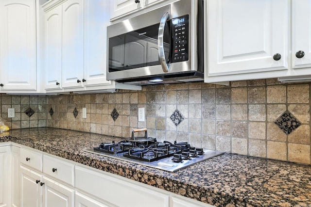 28 Chemin Ct, Little Rock, AR 72223 - kitchen featuring appliances with stainless steel finishes, dark countertops, white cabinetry, and backsplash
