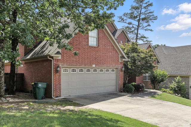 28 Chemin Ct, Little Rock, AR 72223 - view of front facade with brick siding, concrete driveway, and roof with shingles