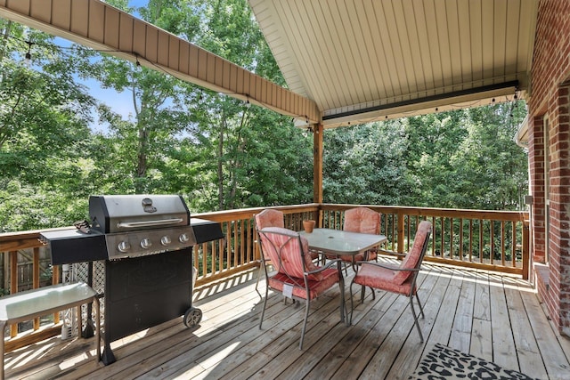 28 Chemin Ct, Little Rock, AR 72223 - wooden terrace featuring area for grilling, outdoor dining area, and view of scattered trees