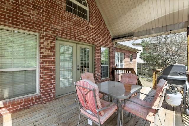 28 Chemin Ct, Little Rock, AR 72223 - wooden deck with outdoor dining area, french doors, and a grill