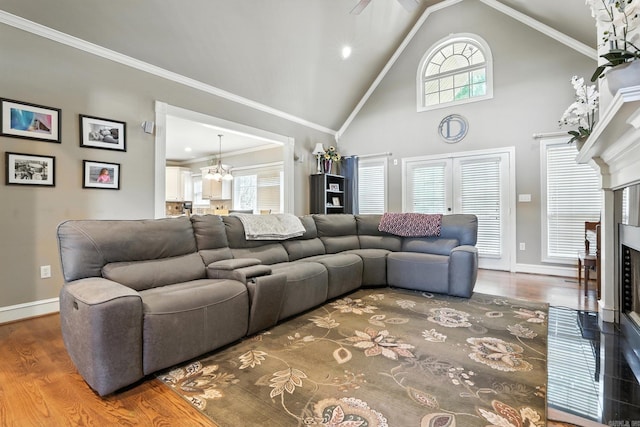28 Chemin Ct, Little Rock, AR 72223 - living area with wood finished floors, healthy amount of natural light, a chandelier, high vaulted ceiling, and ornamental molding