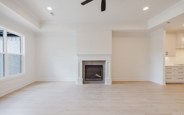127 Edgewood Cir, Little Rock, AR 72223 - unfurnished living room with a raised ceiling, crown molding, light wood-style flooring, ceiling fan, and recessed lighting