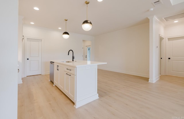 127 Edgewood Cir, Little Rock, AR 72223 - kitchen with ornamental molding, light wood-type flooring, a center island with sink, white cabinets, and light countertops