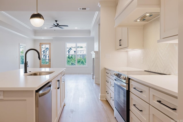 127 Edgewood Cir, Little Rock, AR 72223 - kitchen featuring appliances with stainless steel finishes, custom exhaust hood, tasteful backsplash, light wood finished floors, and light countertops