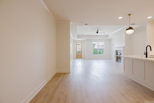 127 Edgewood Cir, Little Rock, AR 72223 - unfurnished living room featuring ornamental molding, light wood finished floors, a raised ceiling, recessed lighting, and a fireplace