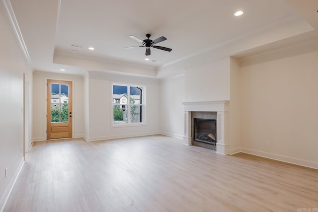 127 Edgewood Cir, Little Rock, AR 72223 - unfurnished living room with a raised ceiling, light wood-style floors, crown molding, a ceiling fan, and a fireplace