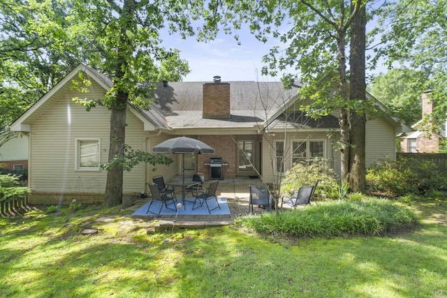 69 Saint Thomas Cir, Little Rock, AR 72211 - rear view of house featuring a lawn, a chimney, and a wooden deck