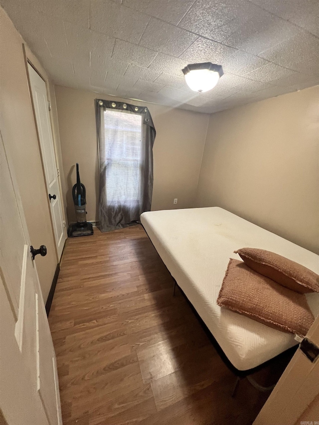 bedroom featuring wood finished floors
