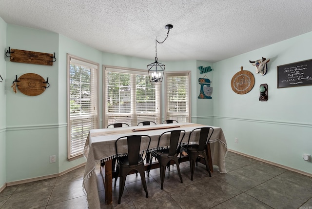 105 Little Creek Rd, Sherwood, AR 72120 - dining space featuring a chandelier, a textured ceiling, and tile patterned floors