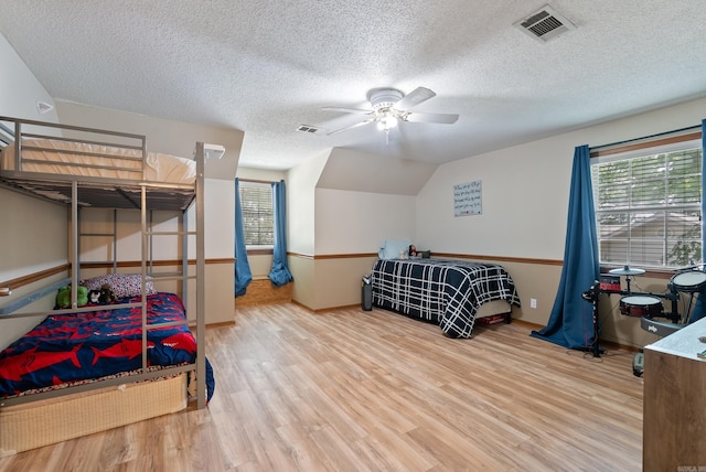 105 Little Creek Rd, Sherwood, AR 72120 - bedroom featuring wood finished floors, a textured ceiling, vaulted ceiling, and a ceiling fan
