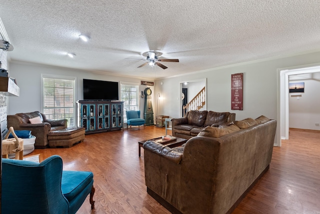105 Little Creek Rd, Sherwood, AR 72120 - living area featuring ceiling fan, a textured ceiling, wood finished floors, ornamental molding, and a fireplace