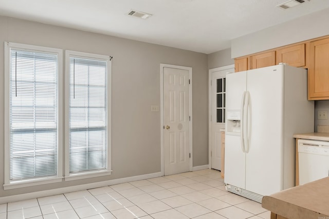 1607 W Washington Ave, Jonesboro, AR 72401 - kitchen with white appliances, light brown cabinets, light tile patterned flooring, and light countertops