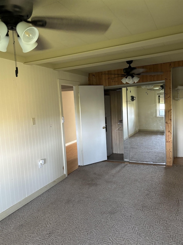 1702 S Ruddle Rd, Blytheville, AR 72315 - carpeted empty room with ceiling fan and wooden walls