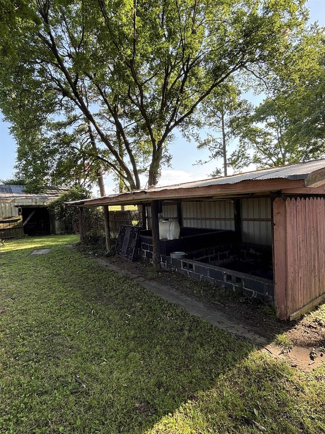 1702 S Ruddle Rd, Blytheville, AR 72315 - view of green lawn featuring a pole building and an outdoor structure