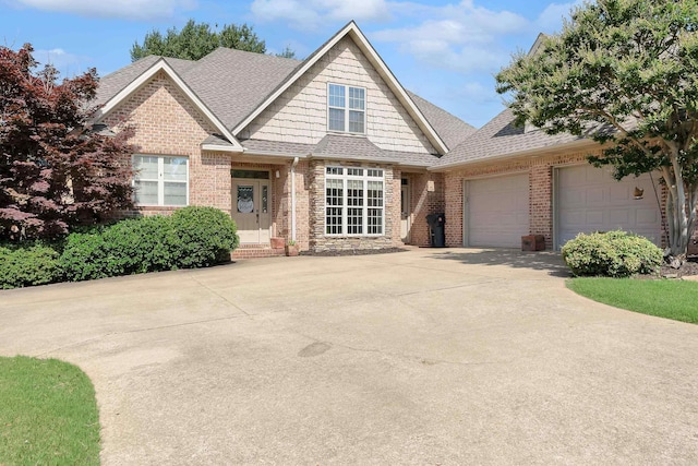 5201 Providence Cir, Jonesboro, AR 72404 - view of front of house with roof with shingles, brick siding, a garage, and driveway
