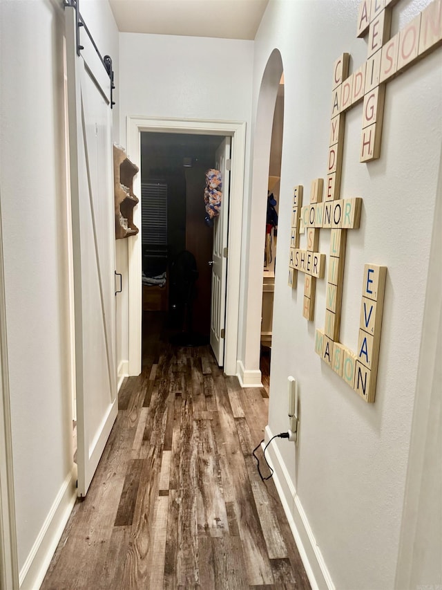 1695 Gardenia, Conway, AR 72034 - corridor with dark wood-type flooring, arched walkways, and a barn door