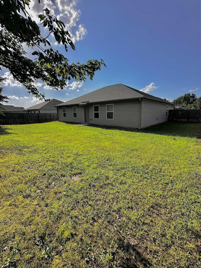 back of property with a fenced backyard