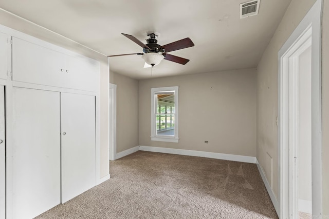 901 S Reine St, Mena, AR 71953 - unfurnished bedroom featuring light carpet, a closet, and ceiling fan