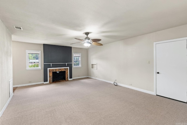 901 S Reine St, Mena, AR 71953 - unfurnished living room with a tile fireplace, carpet, and ceiling fan