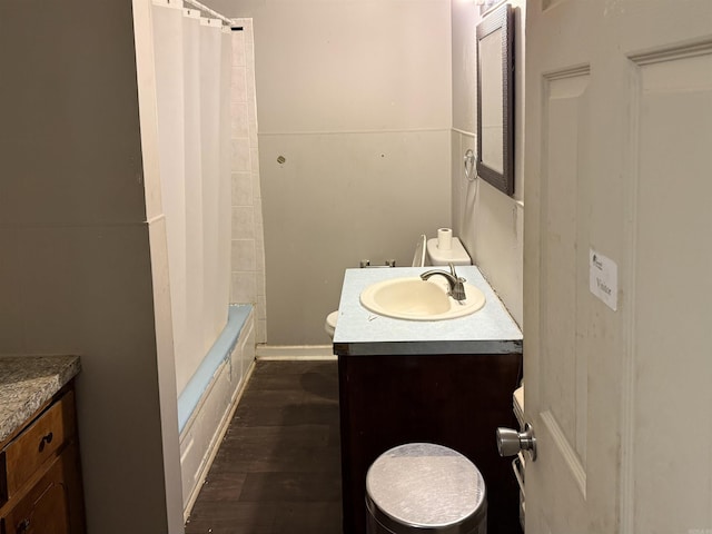 2111 Whyte Dr, North Little Rock, AR 72117 - full bathroom featuring vanity, wood finished floors, and shower / bath combo with shower curtain