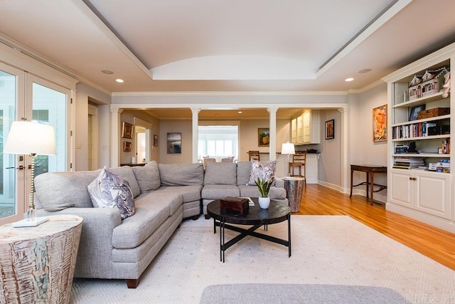 5336 N Grandview, Little Rock, AR 72207 - living area featuring ornate columns, light wood-style floors, crown molding, a tray ceiling, and recessed lighting