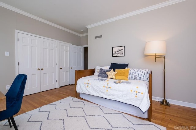 5336 N Grandview, Little Rock, AR 72207 - bedroom with multiple closets, crown molding, and wood finished floors