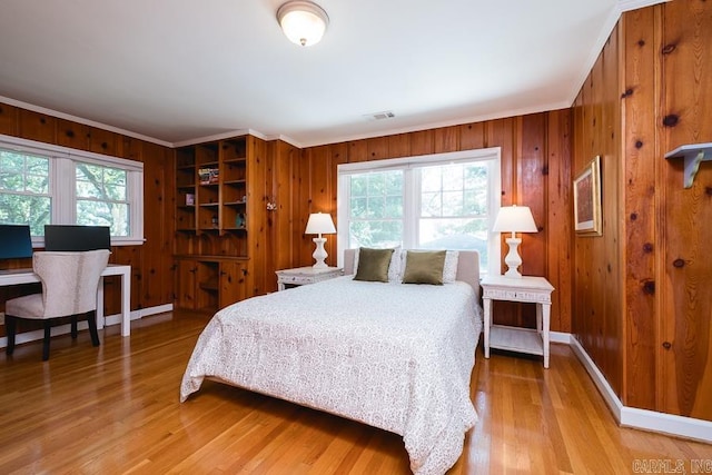 5336 N Grandview, Little Rock, AR 72207 - bedroom with multiple windows, light wood-style flooring, wood walls, and crown molding