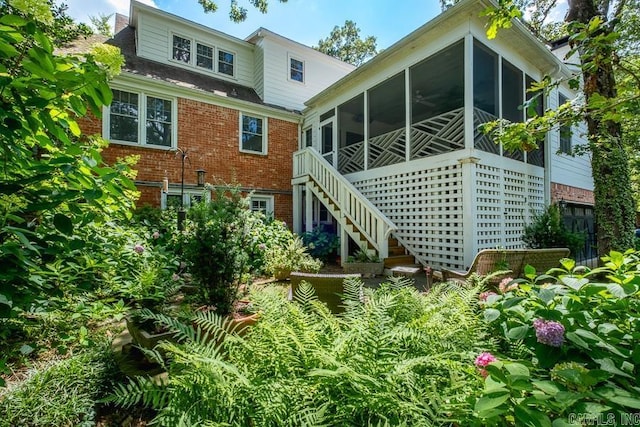5336 N Grandview, Little Rock, AR 72207 - back of house with brick siding, a sunroom, and stairs