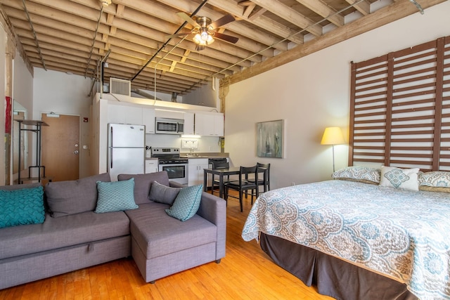 423 E 3rd St Unit 216, Little Rock, AR 72201 - bedroom with freestanding refrigerator and light wood-style floors