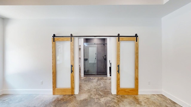 270 Arrowhead Rd, Greenbrier, AR 72058 - spare room featuring a barn door and concrete flooring