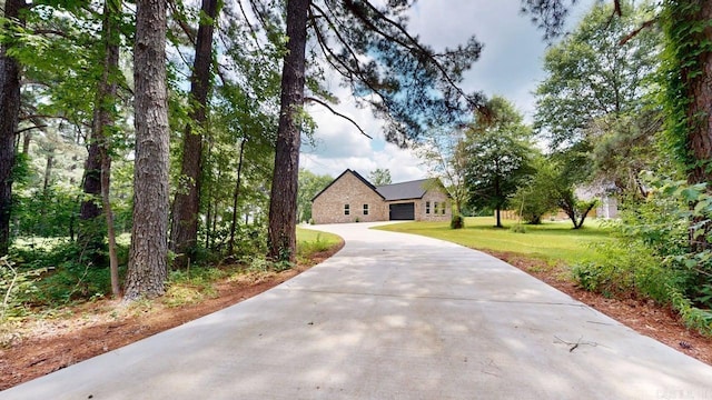 270 Arrowhead Rd, Greenbrier, AR 72058 - view of front of house featuring driveway, a front yard, an attached garage, and stone siding