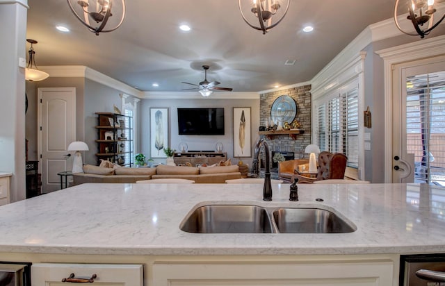 7517 Garden Way, Sherwood, AR 72120 - kitchen featuring open floor plan, light stone counters, a fireplace, recessed lighting, and ornamental molding