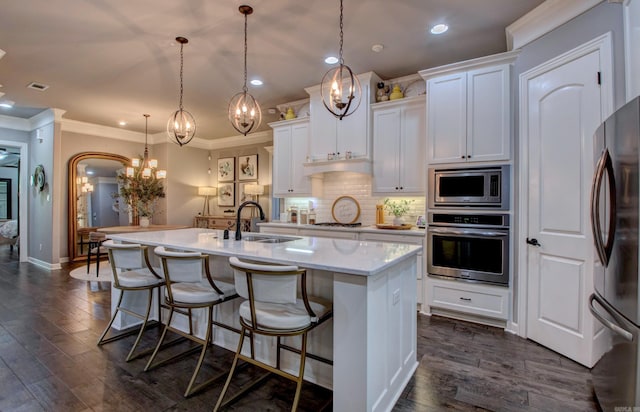 7517 Garden Way, Sherwood, AR 72120 - kitchen with stainless steel appliances, recessed lighting, a kitchen island with sink, tasteful backsplash, and white cabinetry