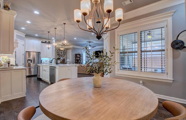 7517 Garden Way, Sherwood, AR 72120 - dining space with a chandelier, recessed lighting, dark wood-type flooring, and crown molding