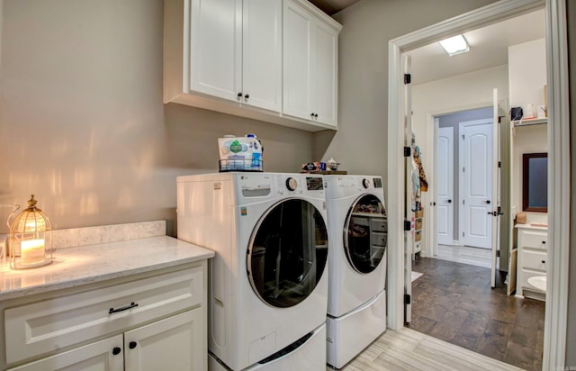7517 Garden Way, Sherwood, AR 72120 - washroom featuring cabinet space, washing machine and clothes dryer, and light wood-type flooring