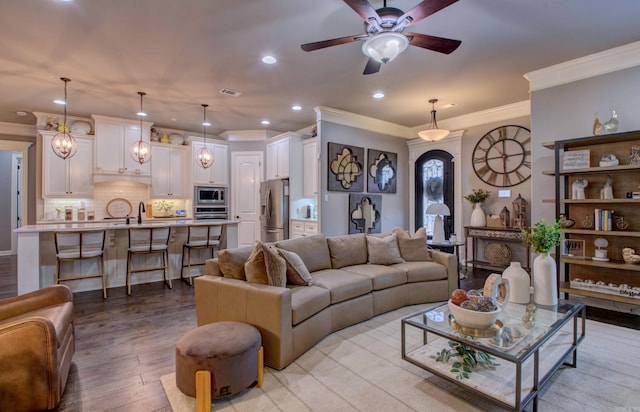 7517 Garden Way, Sherwood, AR 72120 - living area with recessed lighting, ornamental molding, a ceiling fan, and light wood finished floors