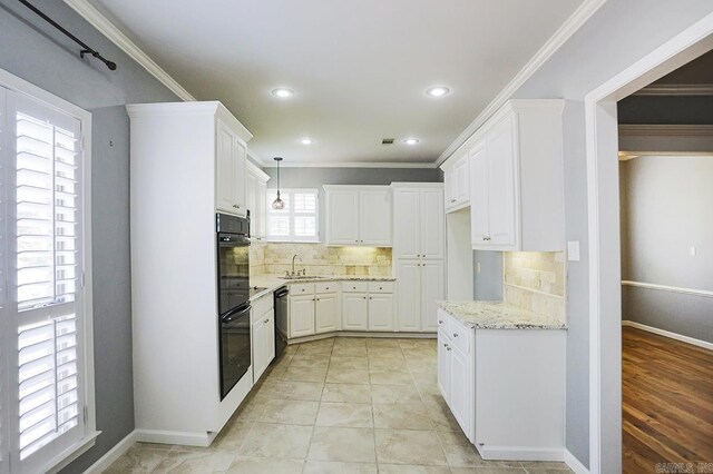 1224 N Pt, North Little Rock, AR 72118 - kitchen featuring backsplash, ornamental molding, white cabinetry, light stone counters, and decorative light fixtures