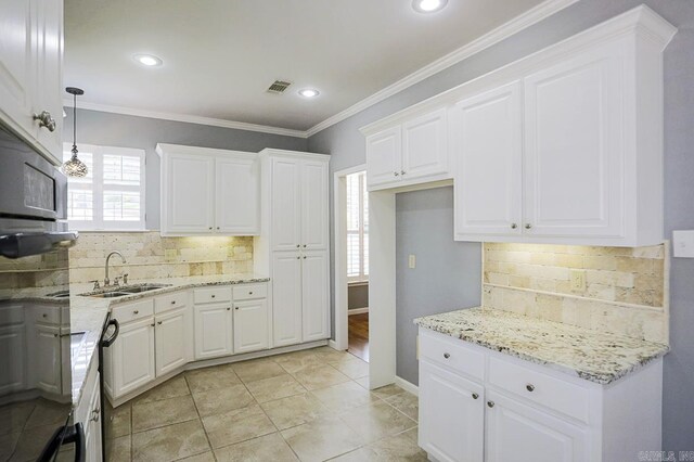 1224 N Pt, North Little Rock, AR 72118 - kitchen featuring healthy amount of natural light, light stone counters, tasteful backsplash, crown molding, and recessed lighting