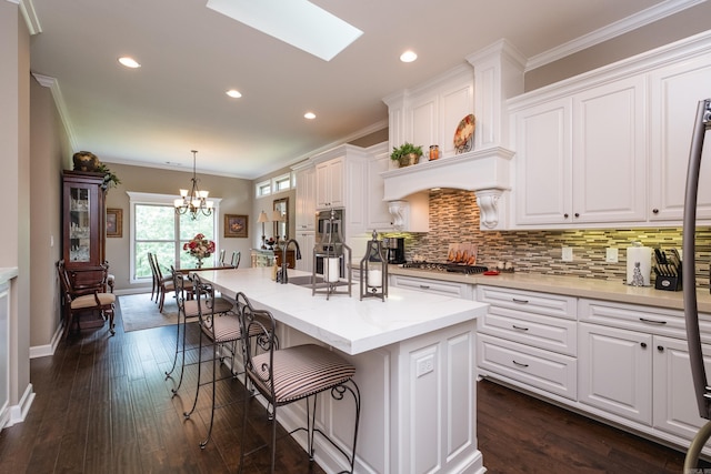 8 Flint Creek Ct, Little Rock, AR 72223 - kitchen with white cabinetry, decorative backsplash, light countertops, ornamental molding, and stainless steel gas cooktop
