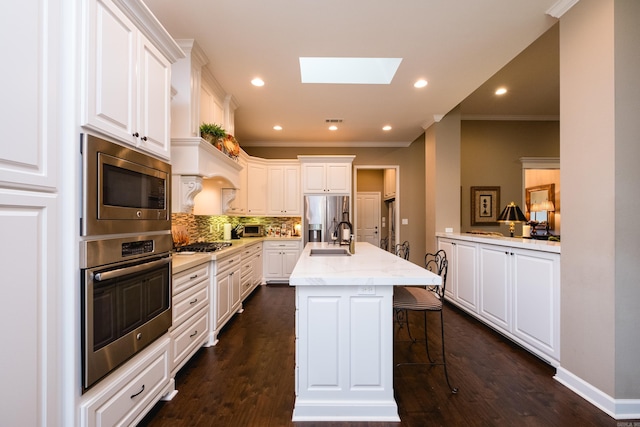 8 Flint Creek Ct, Little Rock, AR 72223 - kitchen with stainless steel appliances, ornamental molding, a skylight, tasteful backsplash, and white cabinets