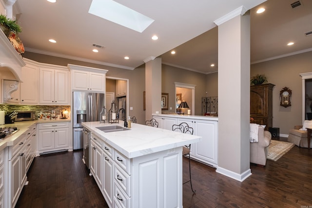 8 Flint Creek Ct, Little Rock, AR 72223 - kitchen with dark wood finished floors, tasteful backsplash, a breakfast bar area, white cabinetry, and crown molding
