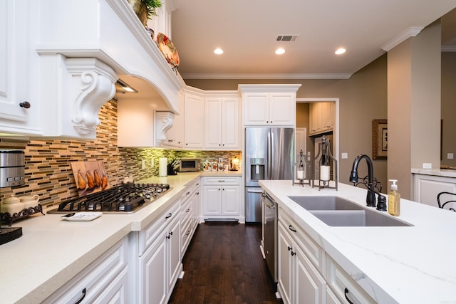 8 Flint Creek Ct, Little Rock, AR 72223 - kitchen with stainless steel appliances, white cabinetry, ornamental molding, dark wood-style floors, and decorative backsplash