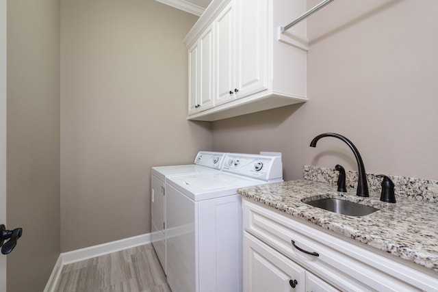 8 Flint Creek Ct, Little Rock, AR 72223 - laundry room with washing machine and clothes dryer, cabinet space, and light wood-style floors