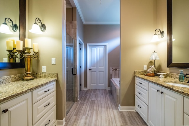 8 Flint Creek Ct, Little Rock, AR 72223 - full bath featuring two vanities, ornamental molding, a stall shower, a garden tub, and wood finished floors