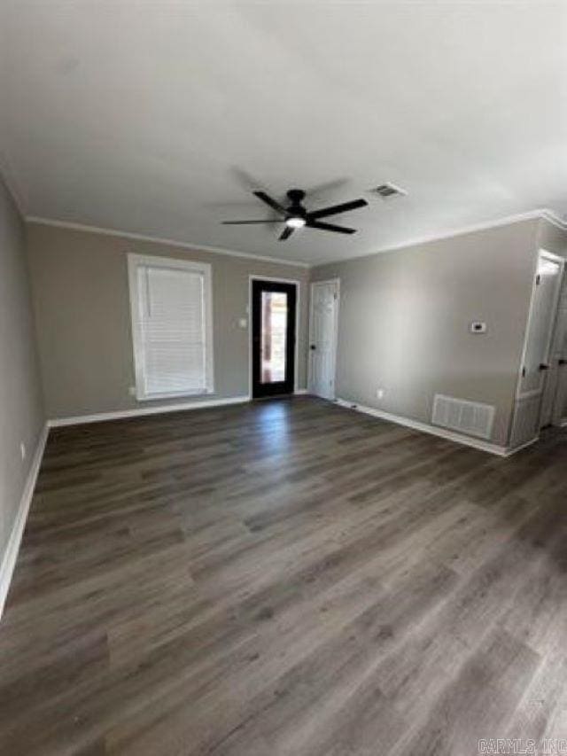 9701 Woodland Dr, Mabelvale, AR 72103 - unfurnished living room featuring wood finished floors, ornamental molding, and a ceiling fan